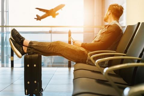 Man with suitcase waiting at the airport