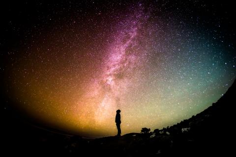 Man looking up at the night sky filled with stars