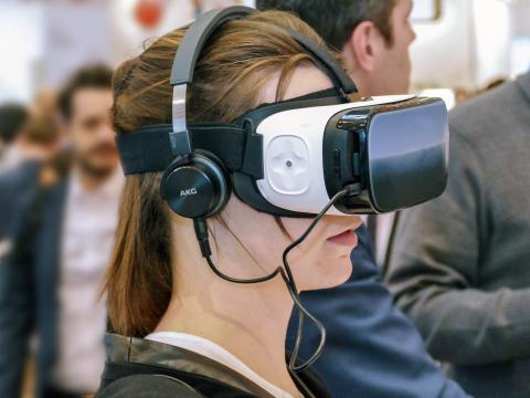 Girl wearing virtual reality goggles.