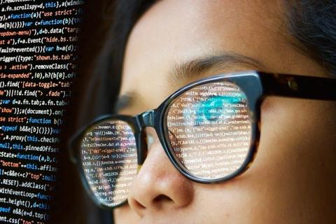 Young woman looking at computer coding