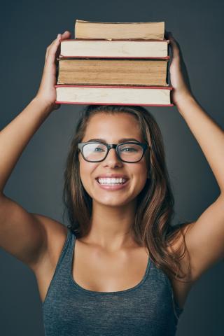 Woman balancing books on her head