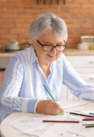 Older adult making a craft.