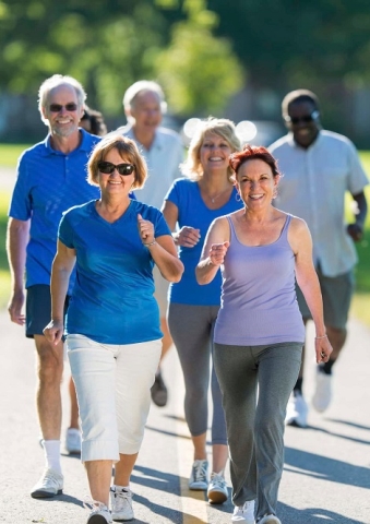 A group of lively seniors walking together outdoors.