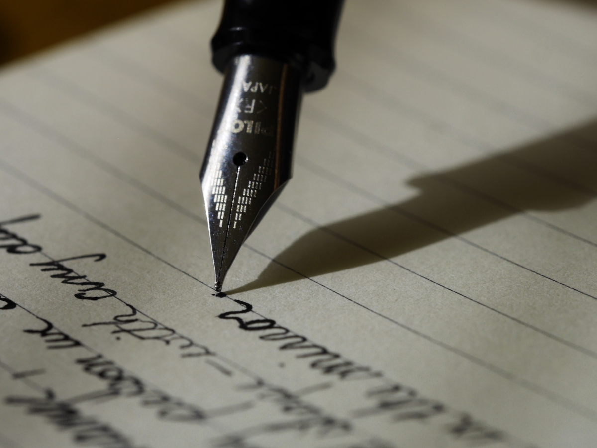 Fountain pen writing on lined paper.