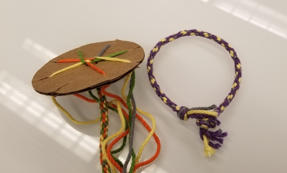 Cardboard loom with bracelet weaving project.