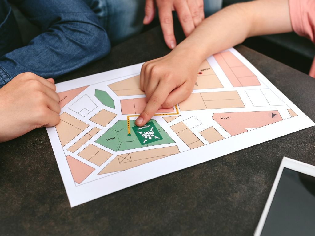 Hands pointing to an Emergency Emergency Plan map.