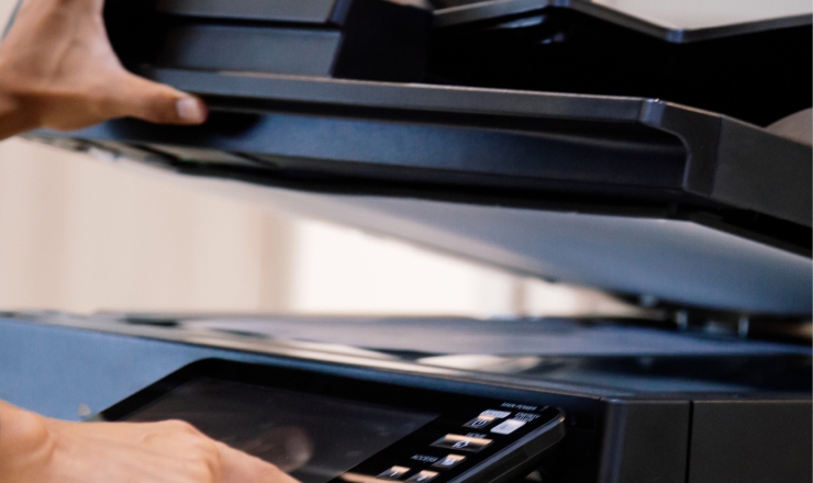 A person using the scanning function on a printer