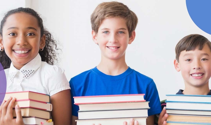 Three children holding big stacks of books.